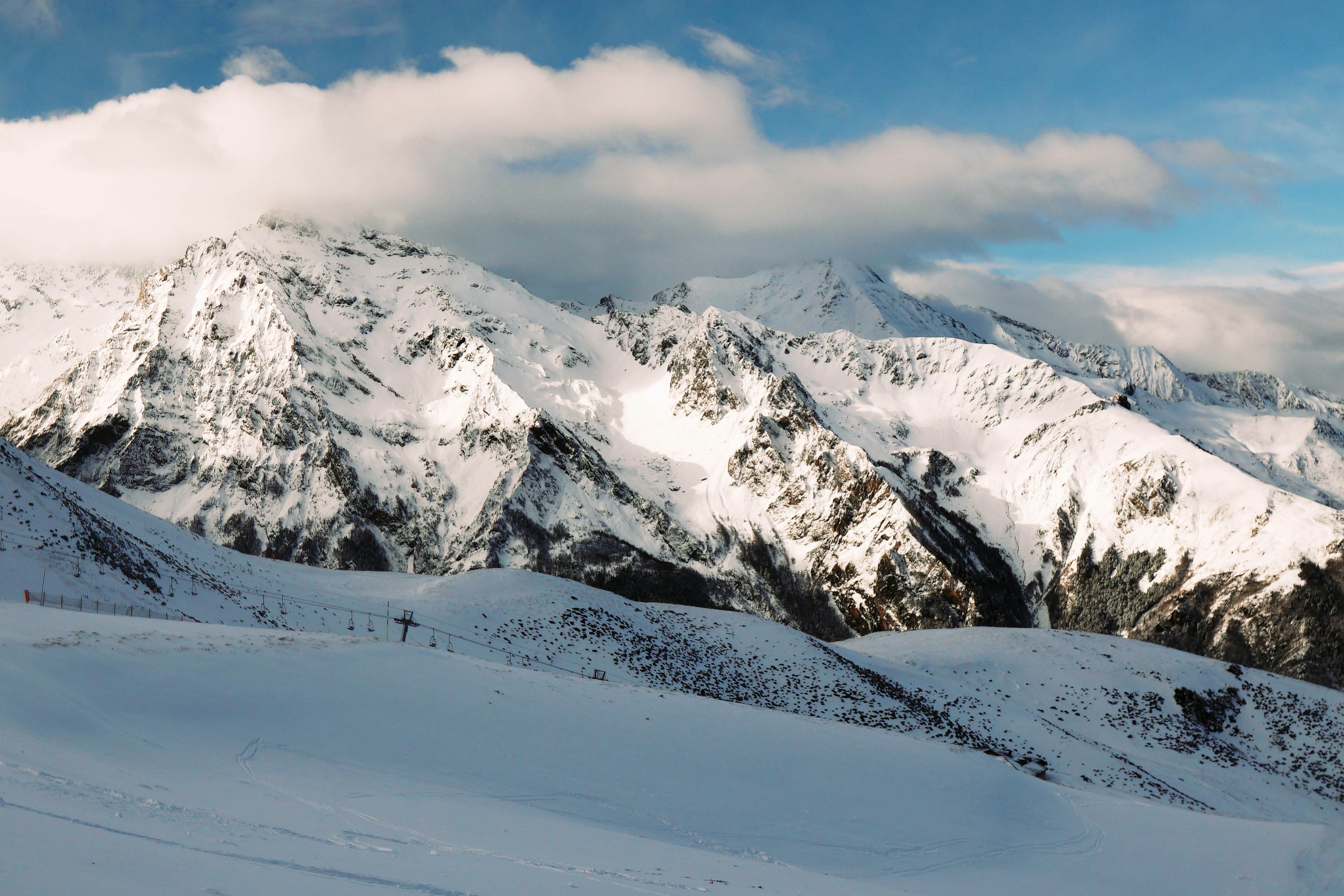 snow covered mountain under cloudy sky during daytime